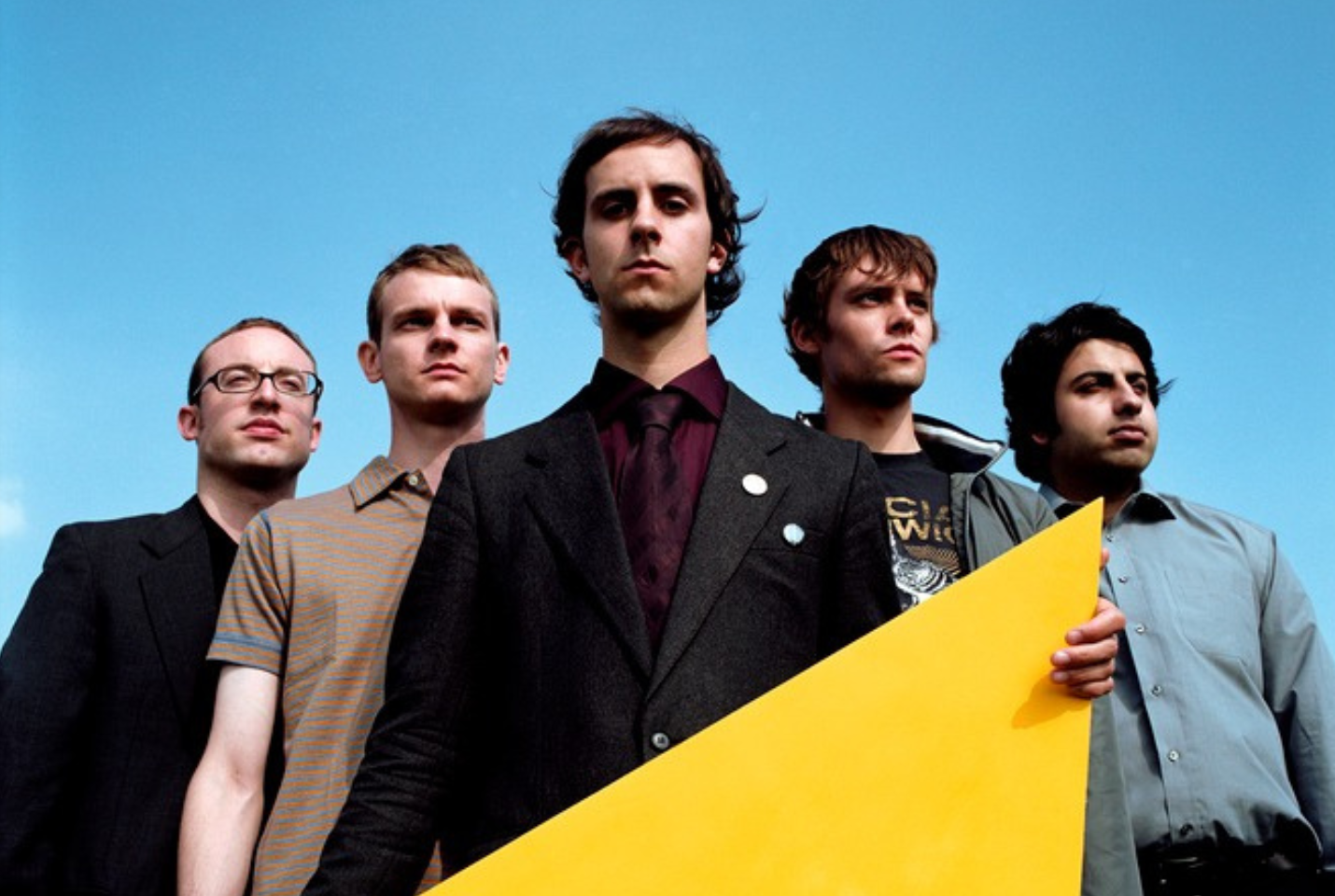 Band Maximo Park with blue sky background, singer holding a yellow object